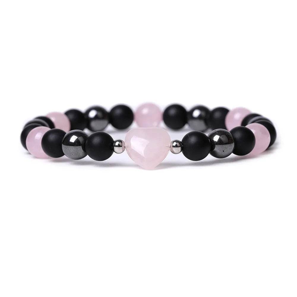Hand-cut peach heart stone bracelet in geometric design with planetary elements