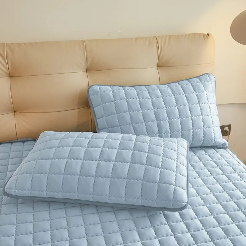 Washed cotton waterproof fitted sheet for beds in blue, shown on a mattress