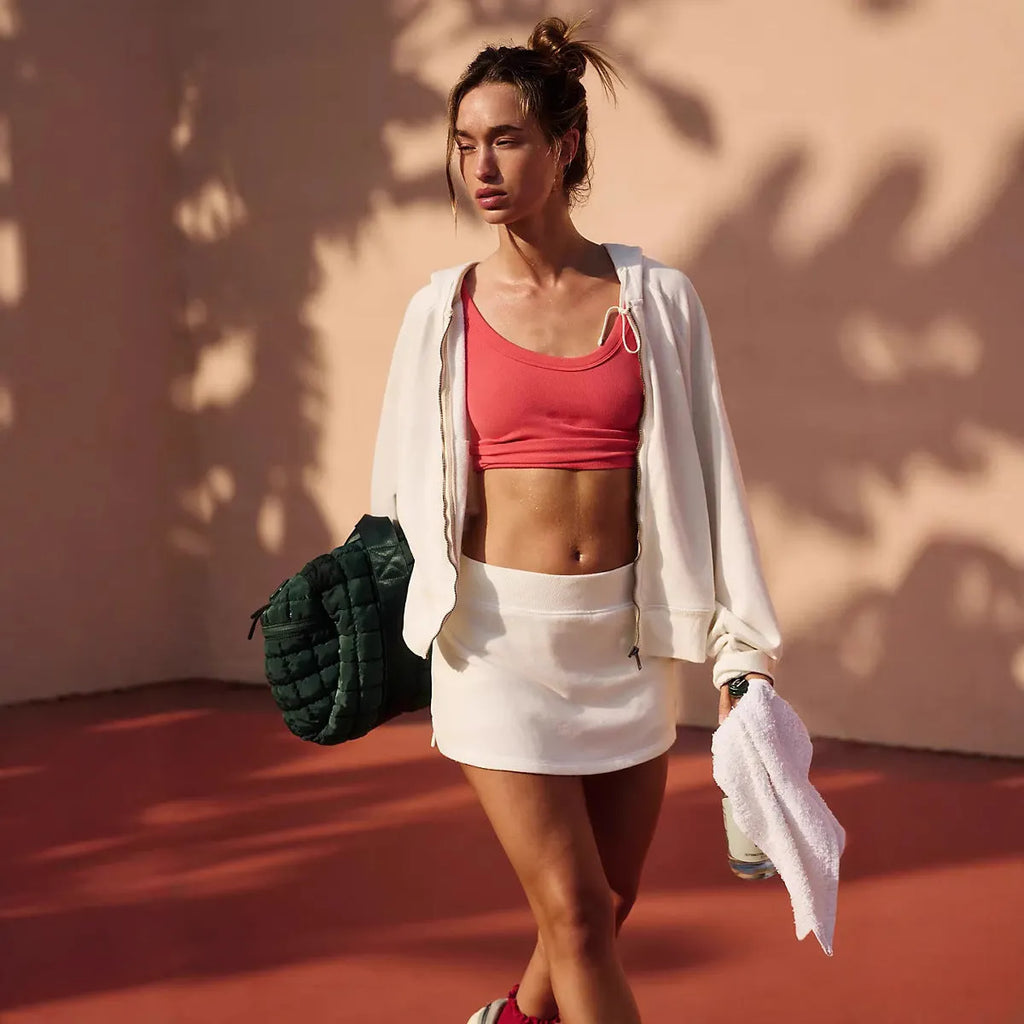 Women's grey hooded jacket and matching miniskirt casual co-ord set on a model.