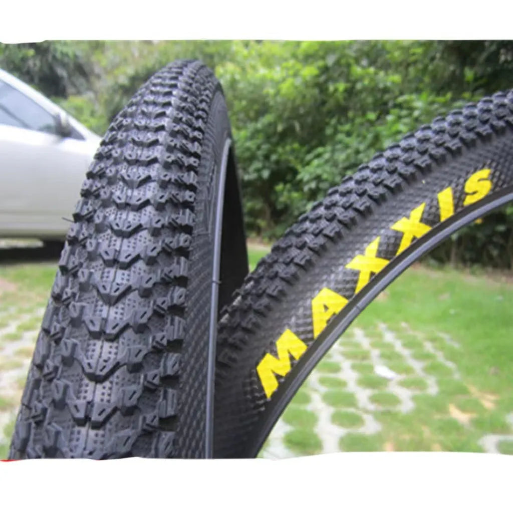 A mountain bike tyre showing tread pattern, with options for 26, 27.5, and 29-inch wheel sizes.