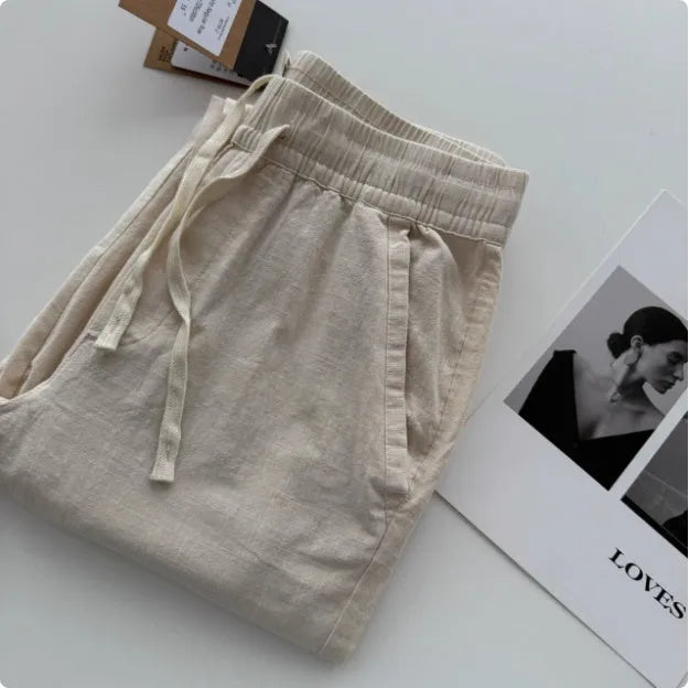 Men's loose-fitting straight-leg casual pants in beige with a drawstring waistband.