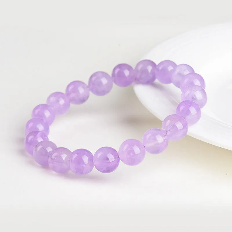 Lavender amethyst crystal bracelet with round beads showing light purple colour and water ripple design.