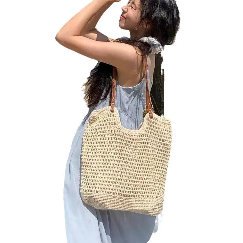 Beige woven cotton linen shoulder bag with a large main compartment.