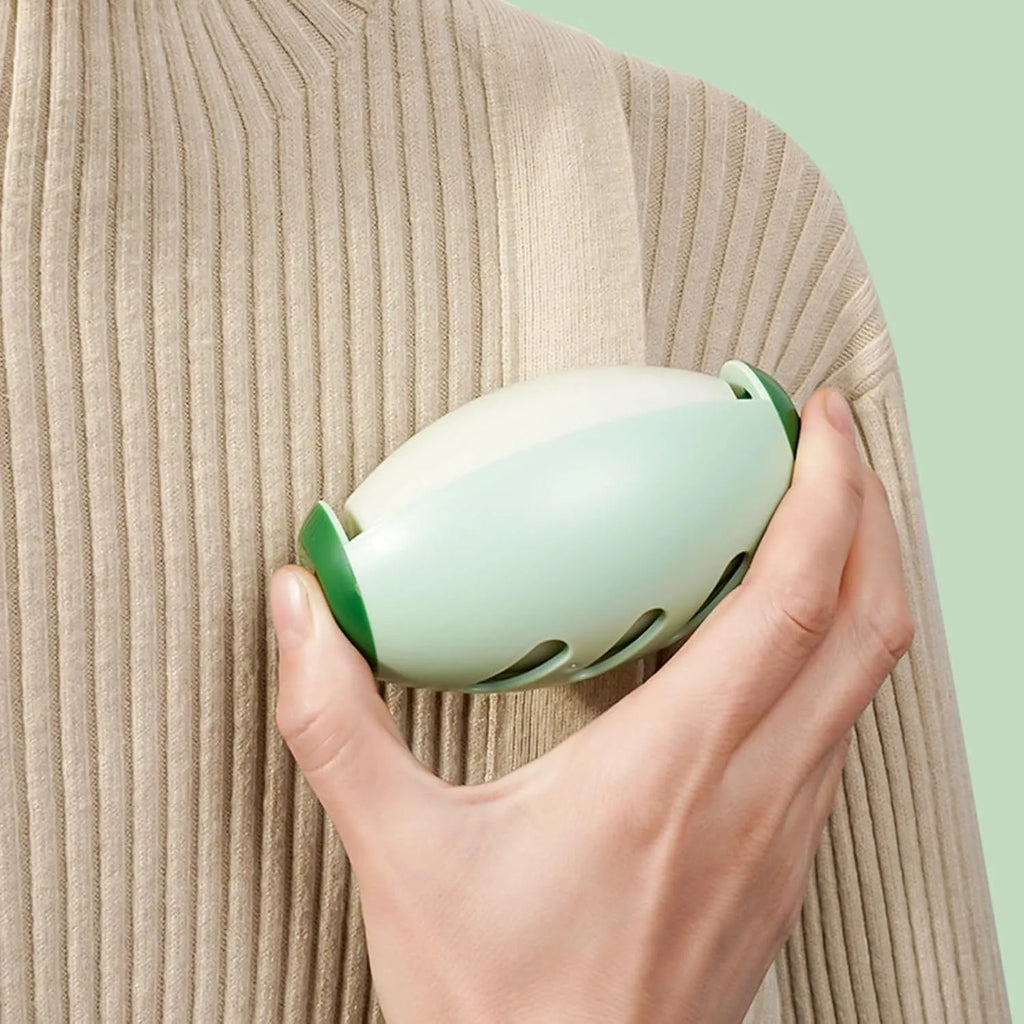 Green and white reusable gel lint roller balls for pet hair removal on fabric