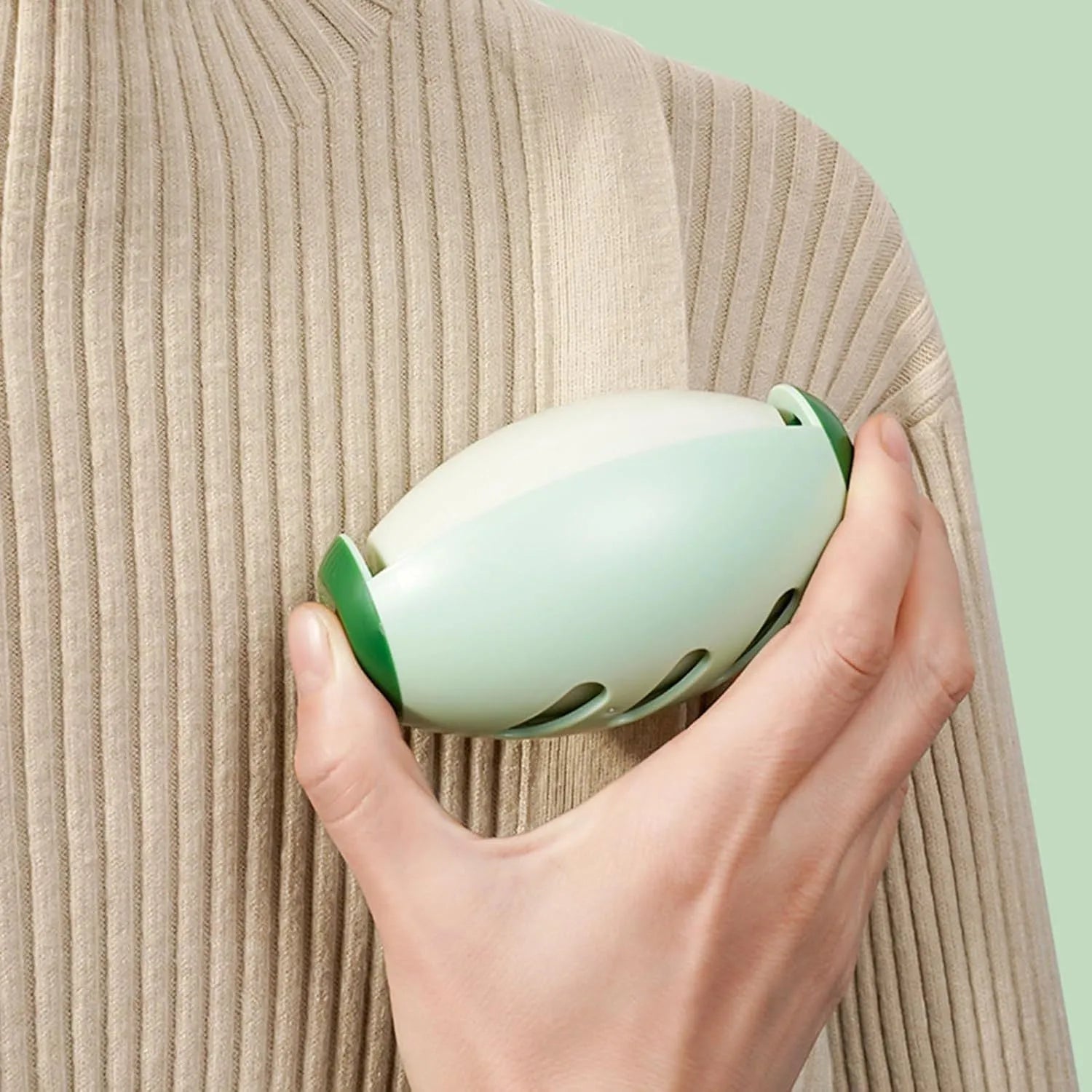 Green and white reusable gel lint roller balls for pet hair removal on fabric