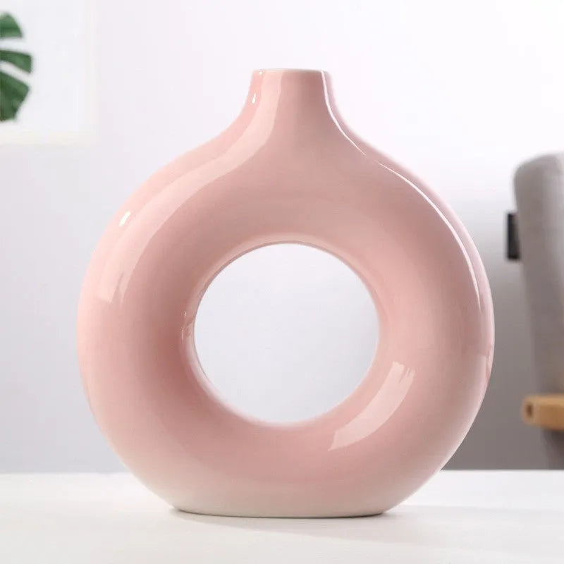 Frosted unglazed porcelain biscuit vase in a simple modern style on a table.