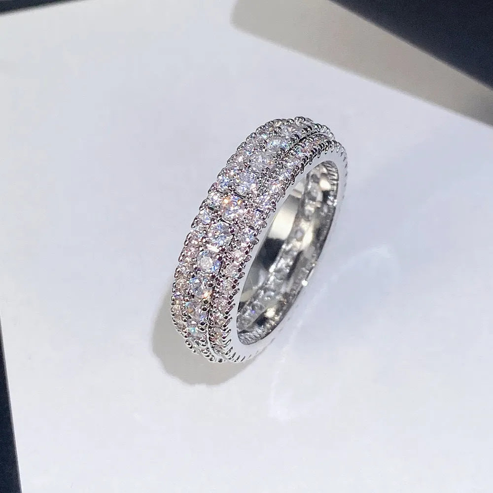 Geometric triangle ring with a zircon stone in a copper band, shown in white gold finish.