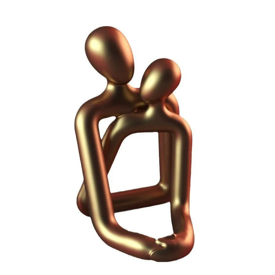 Modern minimalist loving couple resin statue in milky white or gold finish on wooden surface