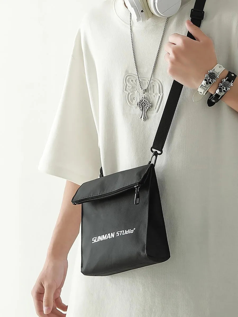 Simple messenger backpack in Oxford fabric with contrast stitching, shown in a choice of four colours.