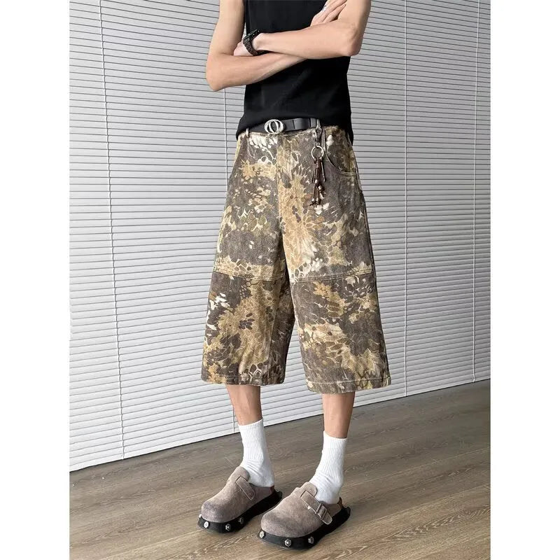 Yellow denim jeans with snake camouflage print and cropped leg length.
