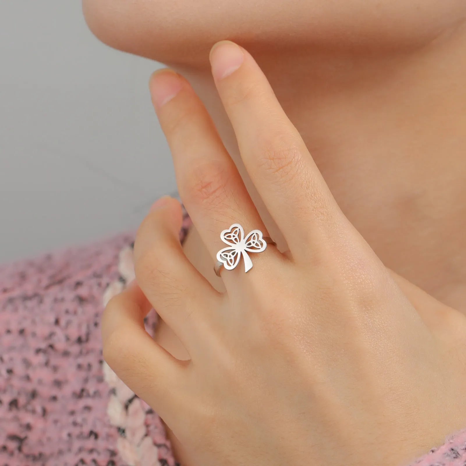 Women's stainless steel lucky hollow ring in gold colour on a hand, showing hollow band construction.