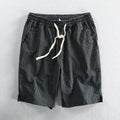 Men's striped loose-fit straight-leg casual shorts on a hanger.
