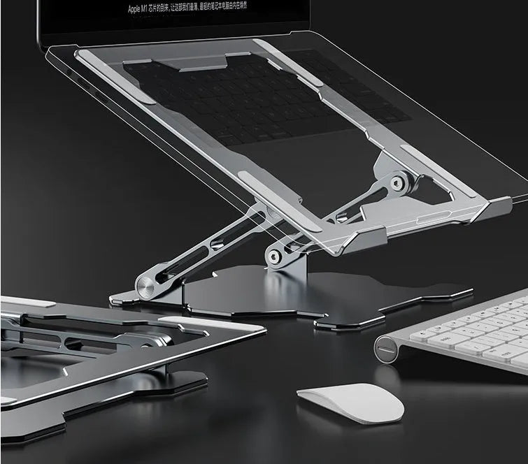 Grey aluminium laptop stand with adjustable angle, folded flat next to a laptop.