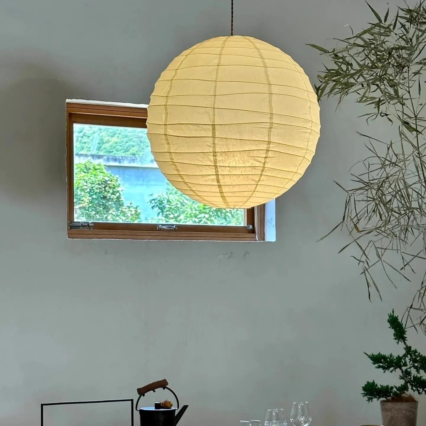 Japanese style rice paper ceiling chandelier light fixture in a living room setting.