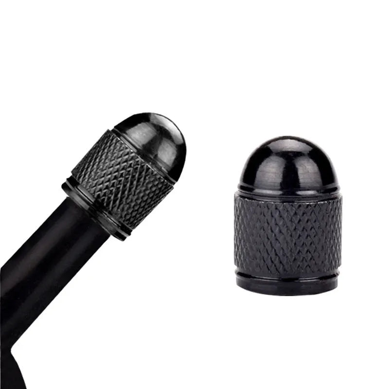 Aluminium alloy mountain bike tyre valve cap in assorted colours on a bicycle wheel.