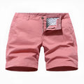 Men's loose-fit blue printed denim shorts with an elastic waistband on a neutral background.
