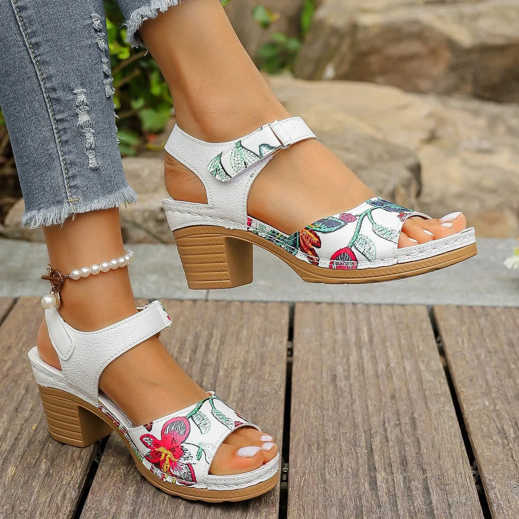 White women's high heel sandals with a Velcro strap buckle on a casual rubber sole.