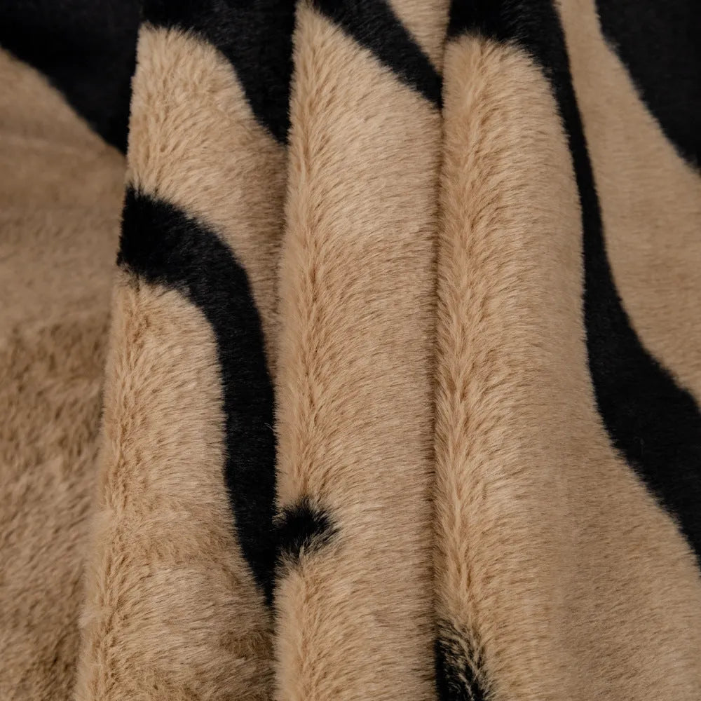 Zebra pattern flannel sofa cover with matching pillowcase on a sofa.