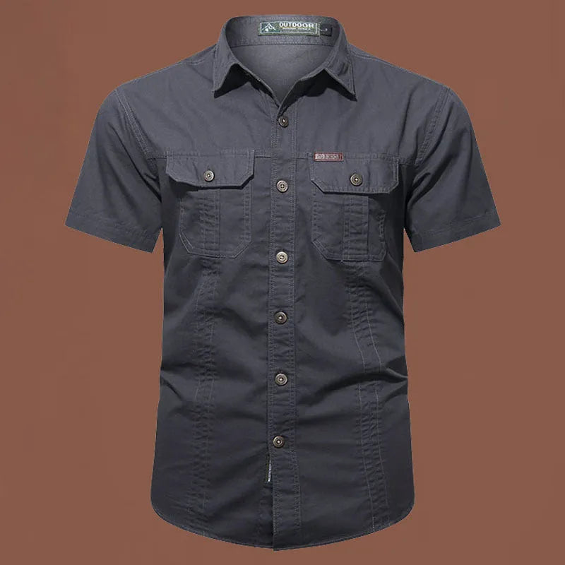 Man wearing a beige cotton short sleeve work shirt with a cardigan style and loose fit.