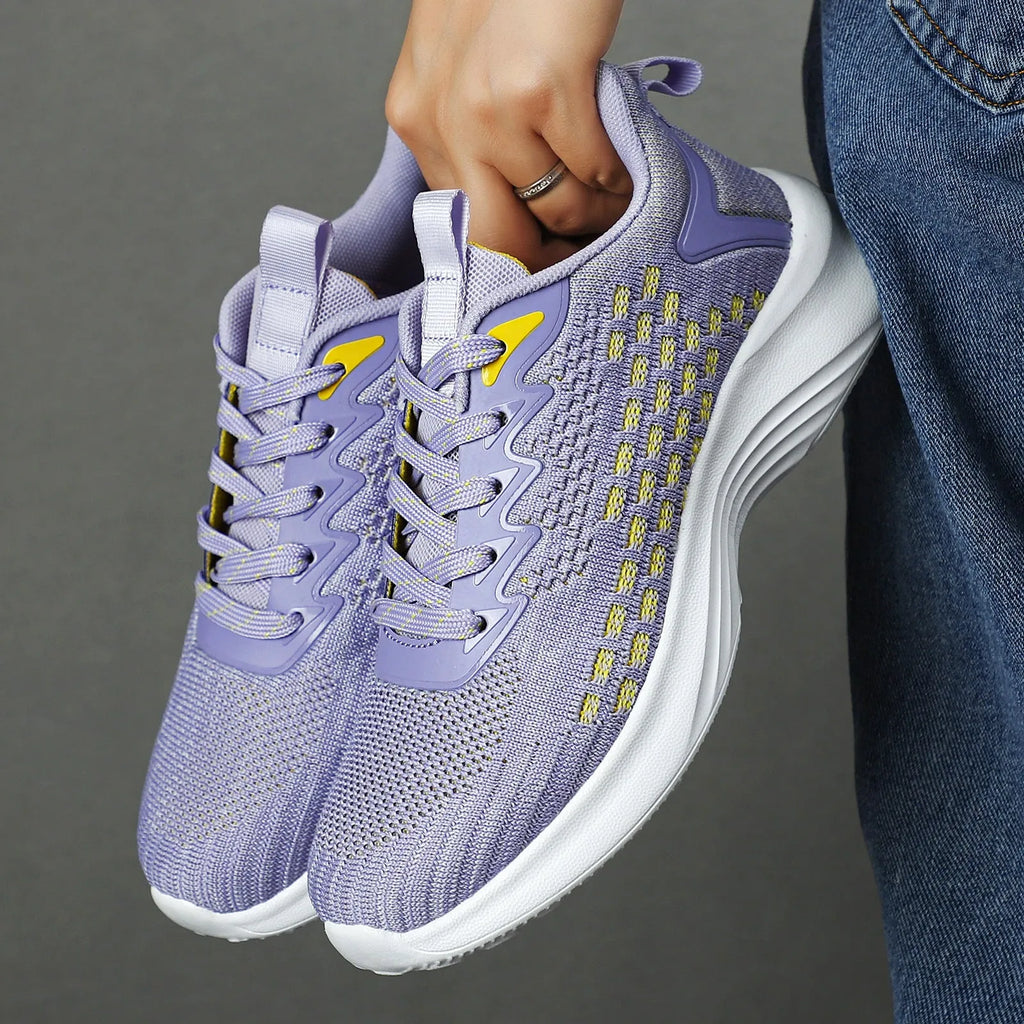 Women's lavender purple Flyknit running shoes with mesh upper and EVA sole on a white background.