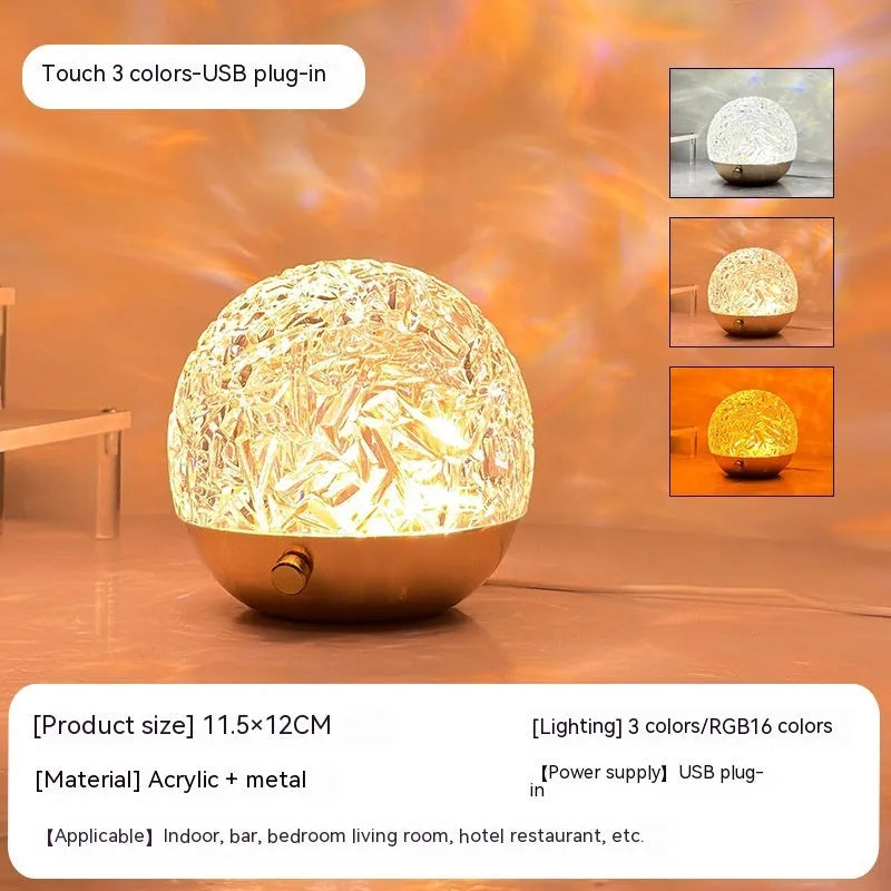 Water ripple projector night light with crystal-like acrylic body and colourful ripple patterns on a bedside table