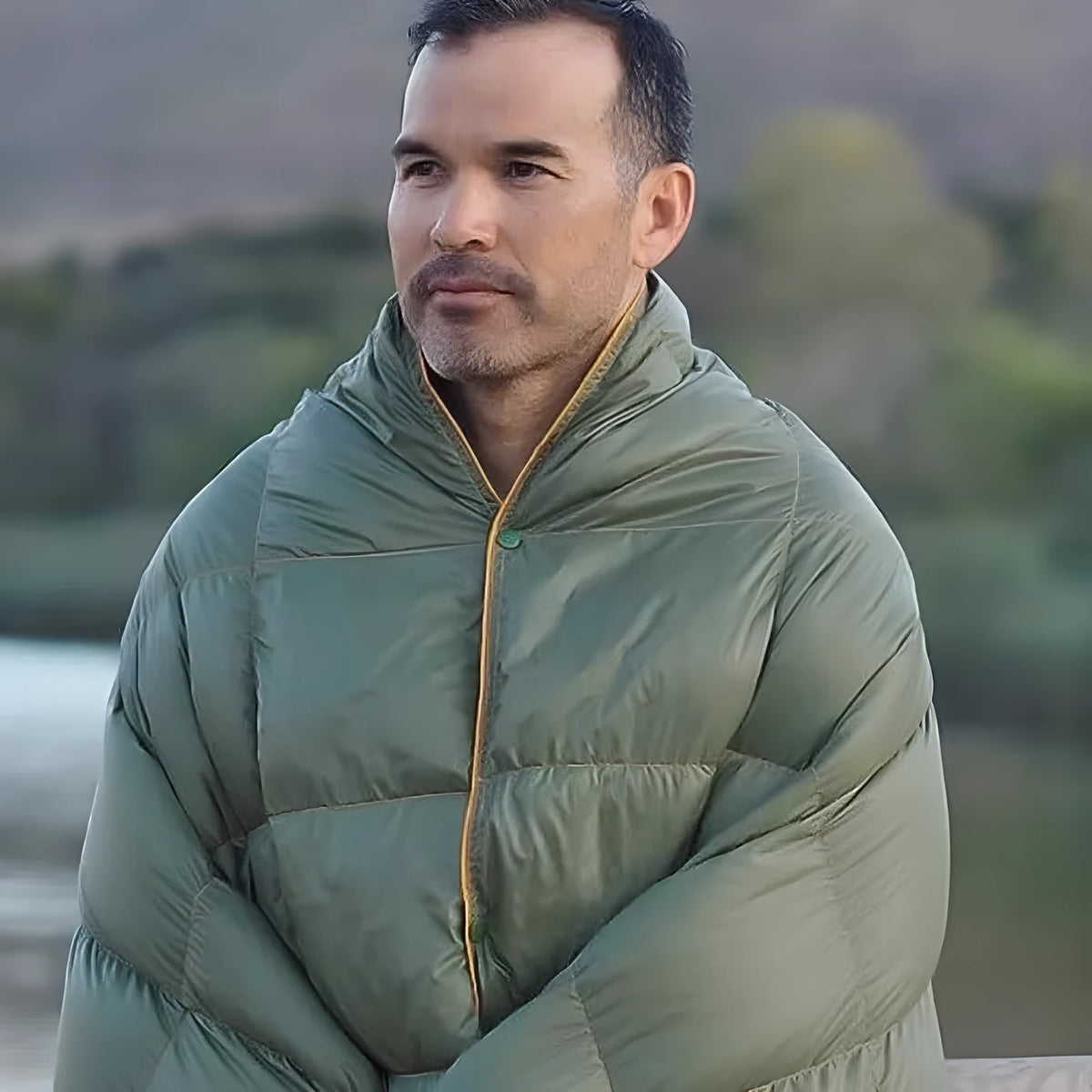 Army green outdoor portable down shawl camping blanket, 140 x 200cm, shown folded and worn over shoulders