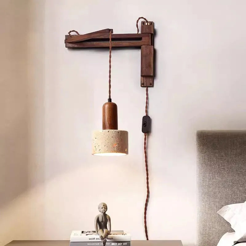 Yellow cave stone wall lamp with textured finish installed above bedside table