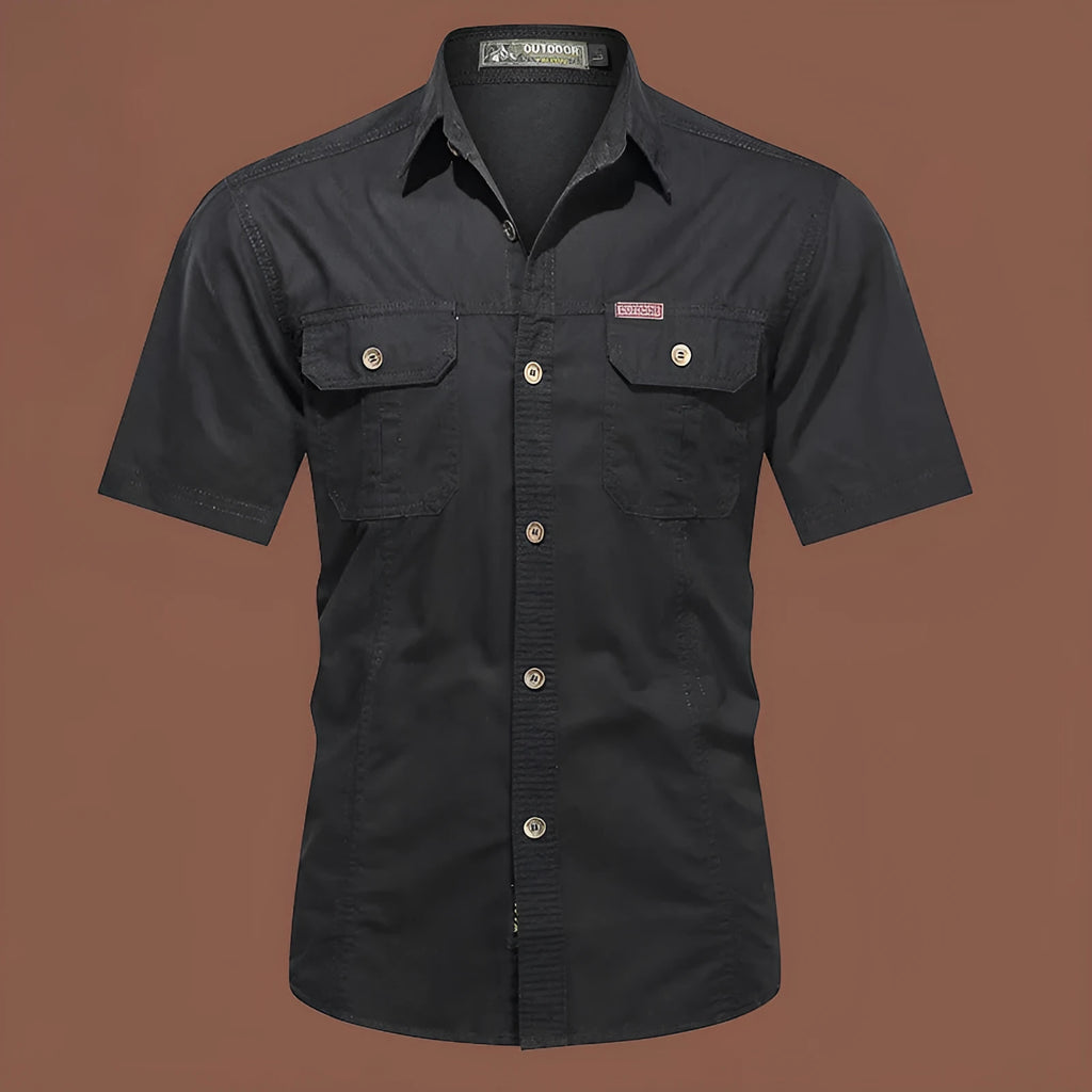 Man wearing a beige cotton short sleeve work shirt with a cardigan style and loose fit.