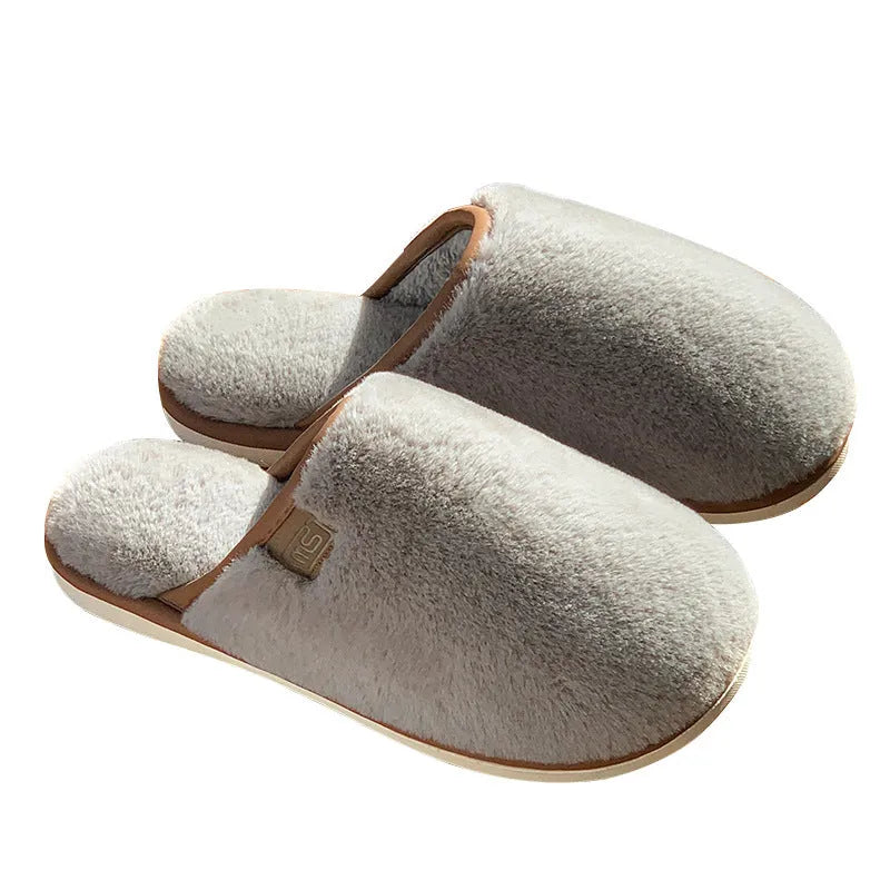 Winter plush slippers in blue with non-slip PVC sole and car stitching detail on the upper.