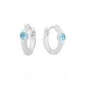 Geometric round ear clips in burnt silver colour on a white background