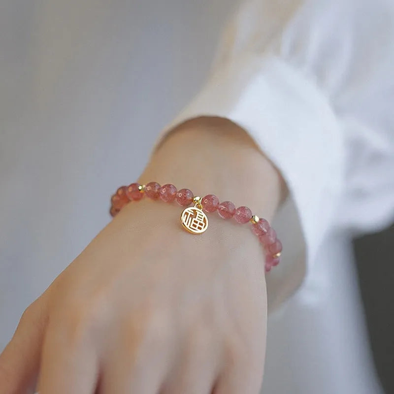 Handmade women's glass bracelet with strawberry quartz beads and blessing card