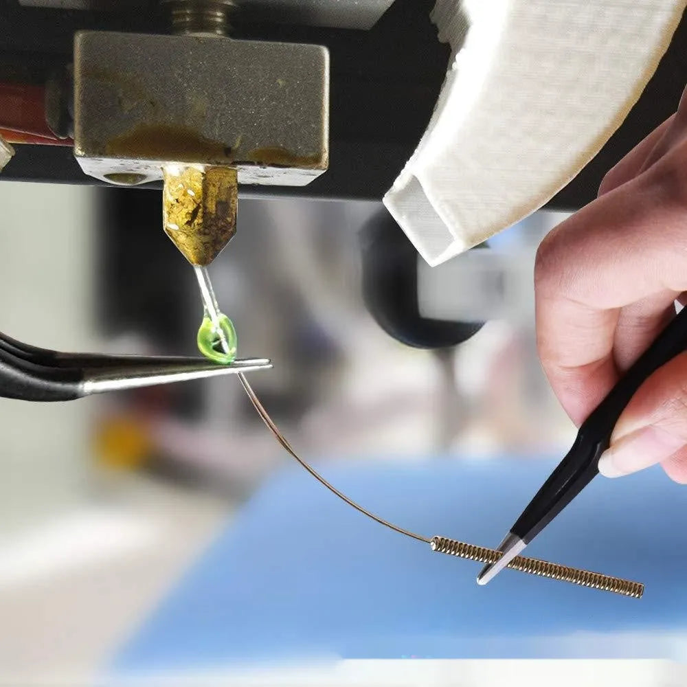 MK8 brass 3D printer nozzle and stainless steel cleaning pin set on a white background.