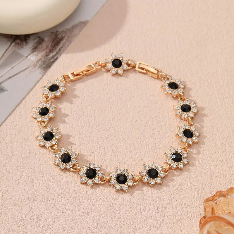 Coloured gemstone bracelet with flower-shaped design in gold and silver colour variations