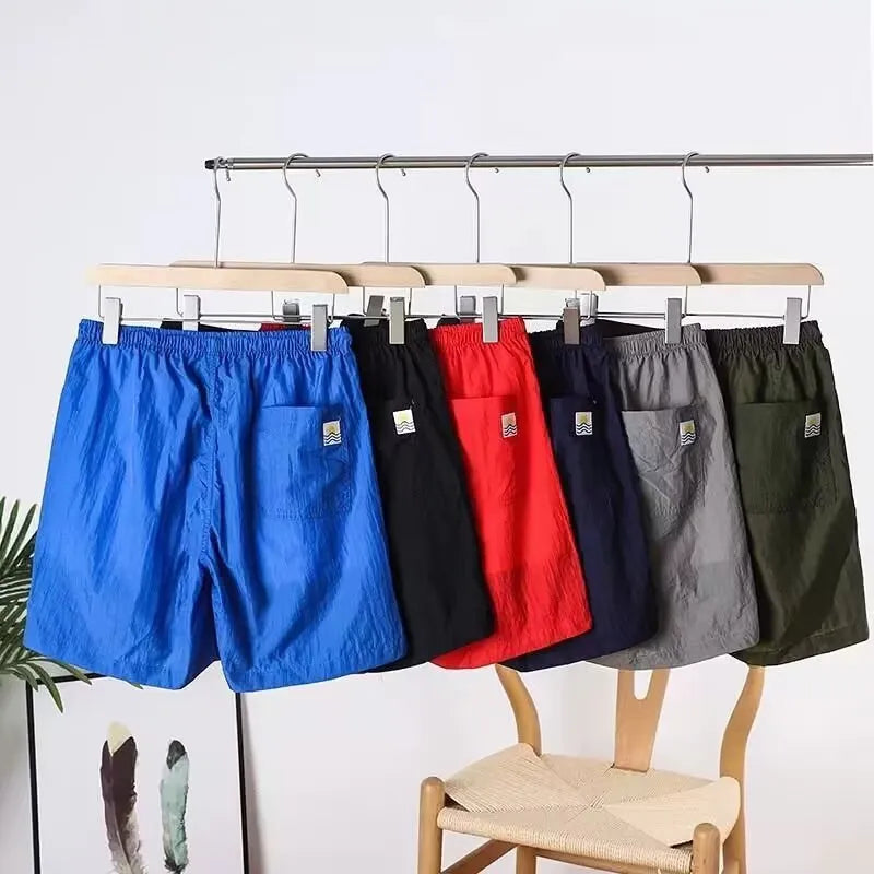 Men's quick-drying straight-leg sports shorts in polyester blend fabric, shown in multiple colour options
