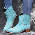 Women's blue embroidered cowboy boots with low wedge heel and pointed toe.