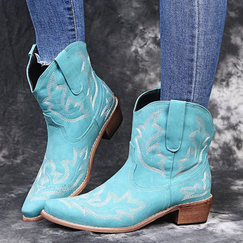 Women's blue embroidered cowboy boots with low wedge heel and pointed toe.