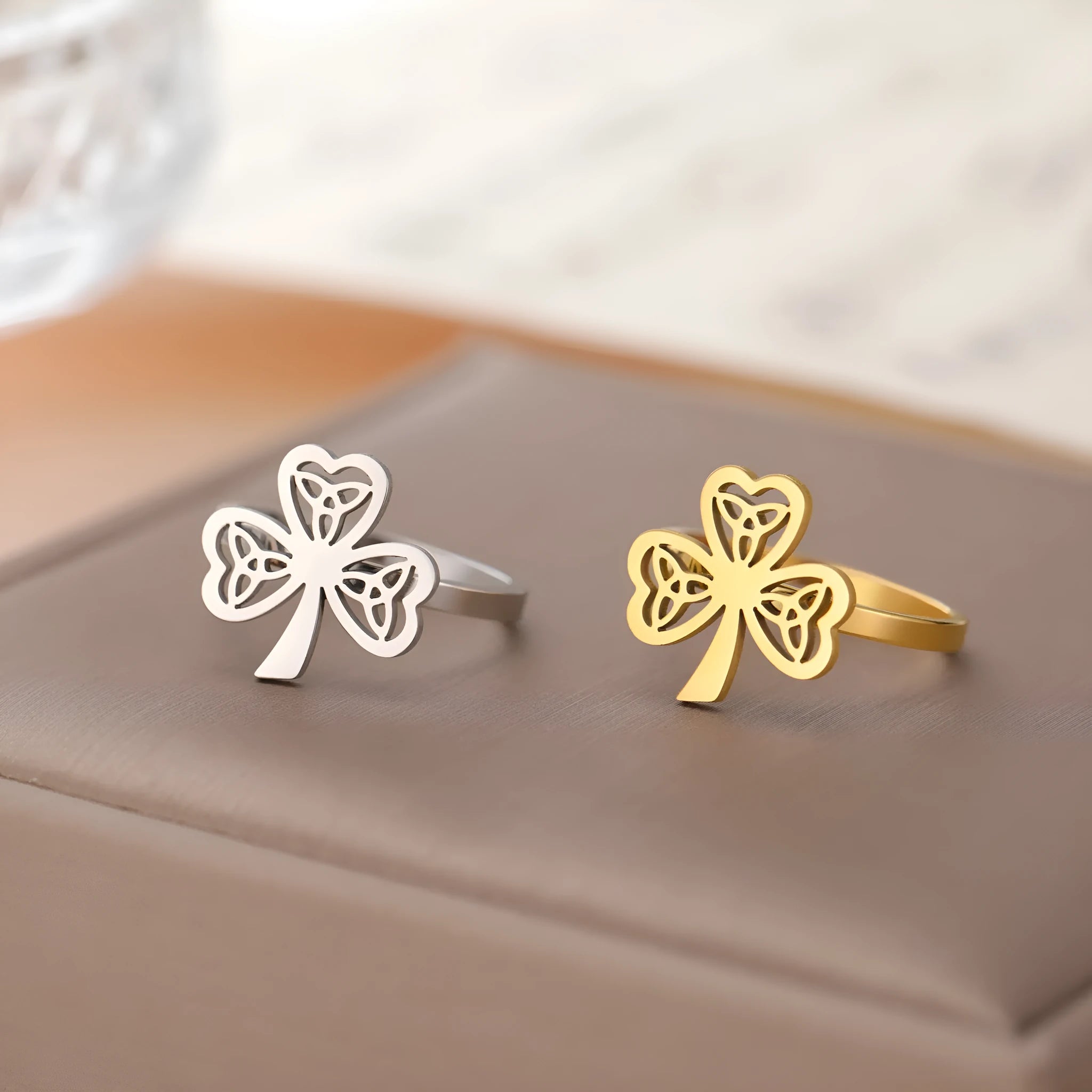 Women's stainless steel lucky hollow ring in gold colour on a hand, showing hollow band construction.