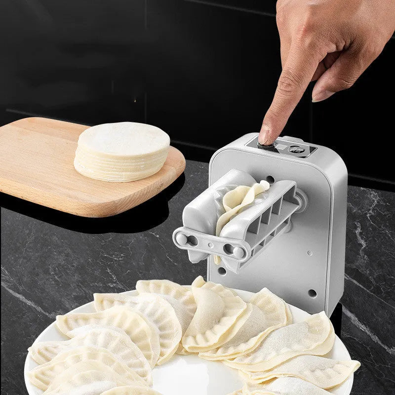 White automatic electric dumpling maker machine with USB charging cable on a kitchen counter