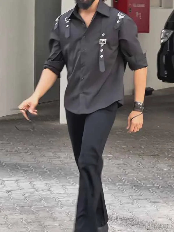 Man wearing a black utility-style button-up shirt with a regular fit.