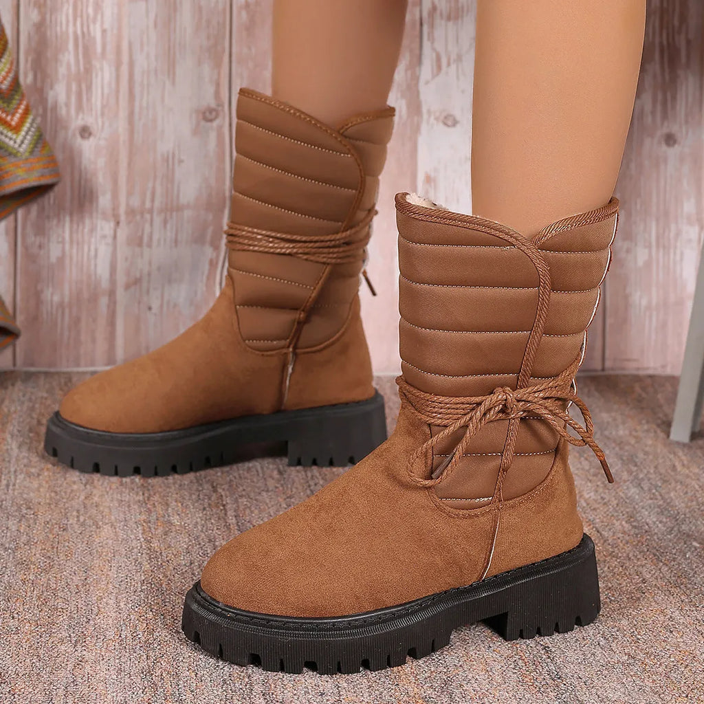 Women's black suede high-top snow boots with chunky rubber sole and lace-up design.