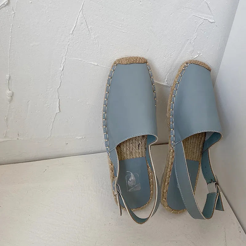 Women's beige retro-style flat sandals with an animal pattern on the canvas upper.