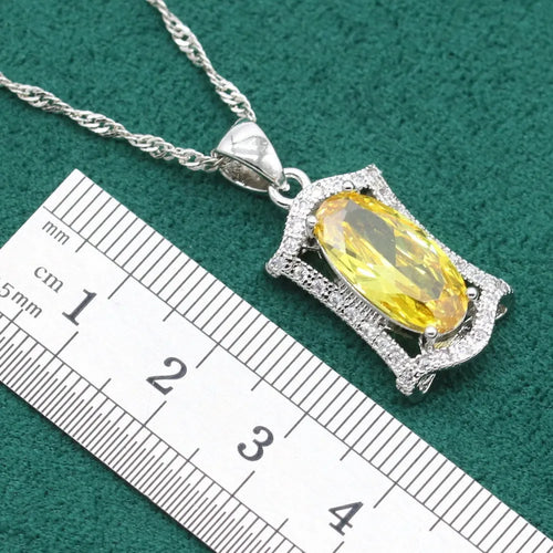 Yellow anti-allergy zircon jewellery set with snake bone chain necklace, earrings, ring, and bracelet on display.