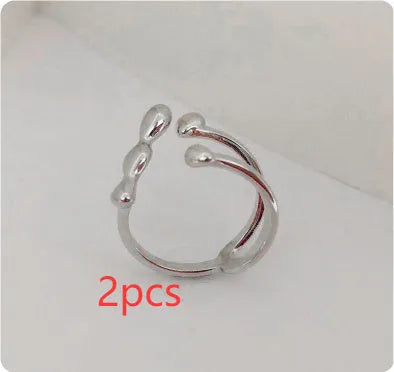 Brass ring with a spherical design on a circular band, shown in gold and silver finishes.