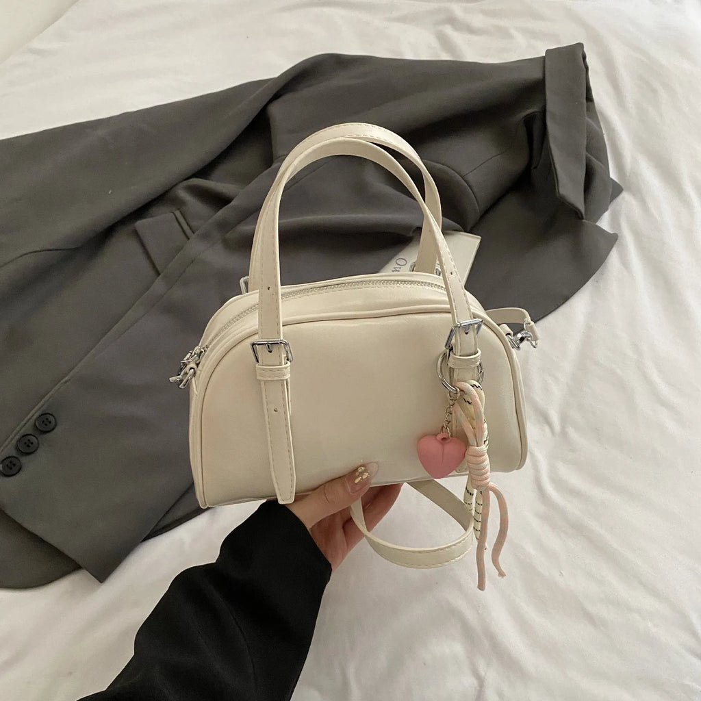 Women's square shoulder bag in PU leather with soft shell shape and optional ribbon pendant