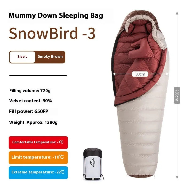 Goose down mummy sleeping bag in a stuff sack, part of the snowbird range for camping.