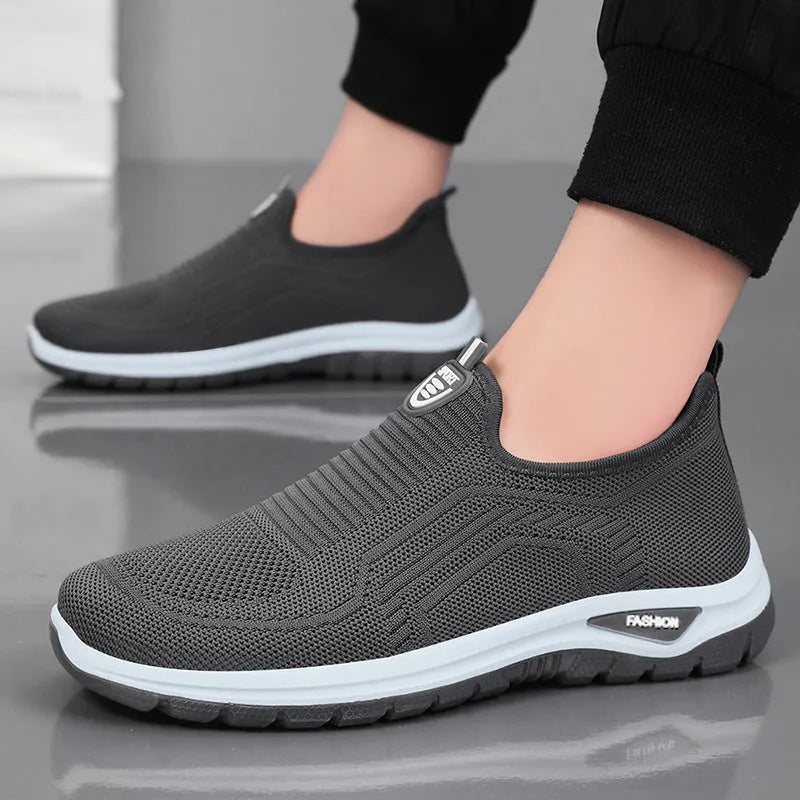 Men's black and grey breathable casual tennis shoes with mesh upper and round toe.