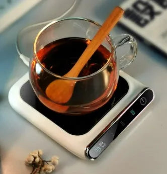 Black mini USB cup warmer with heating coaster on a desk