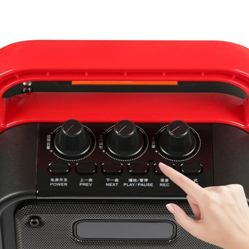 MS62AI black portable Bluetooth speaker with wireless microphone and remote control on a table.