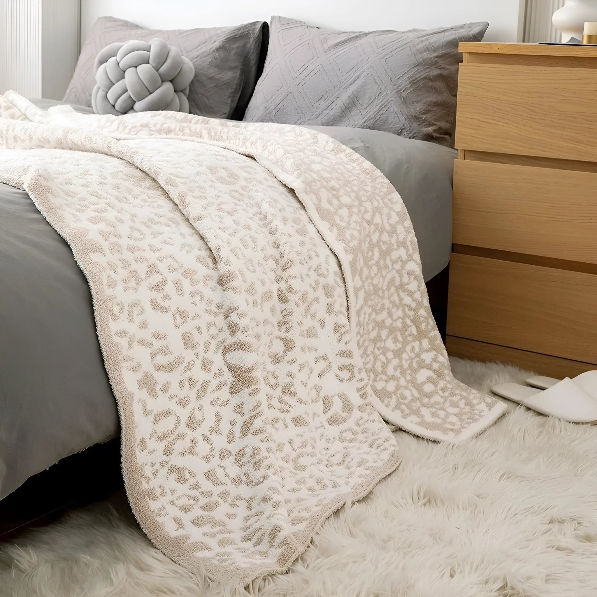 Half velvet leopard print knitted blanket in gray on a sofa, size 130x150cm