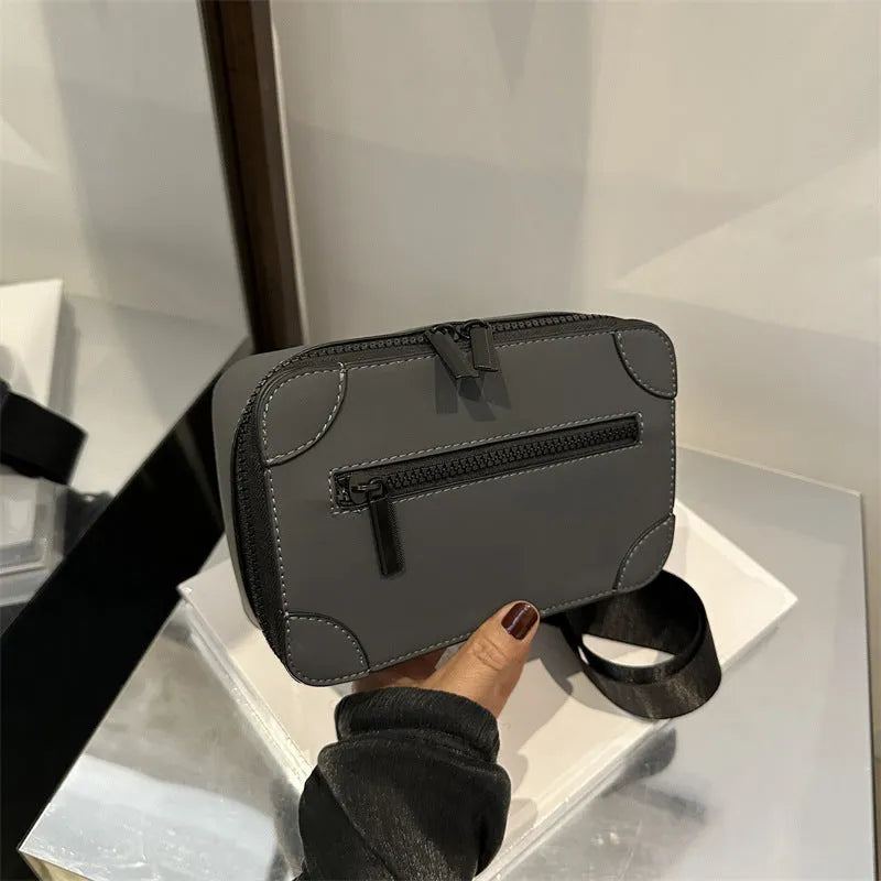 Women's black PU leather square crossbody bag with adjustable strap and outer pocket.